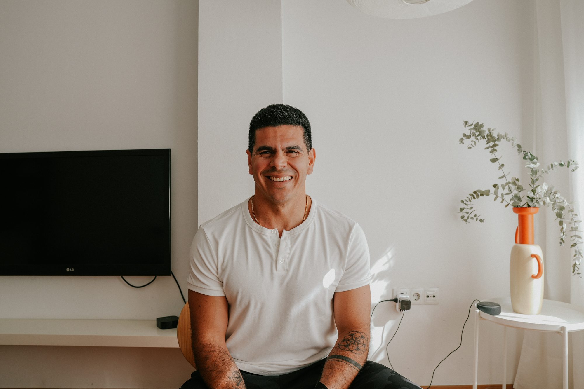 Andres Ayesta seated at home, smiling
