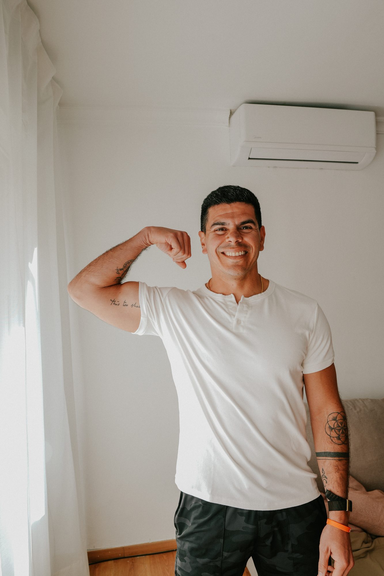 Andres Ayesta flexing and smiling